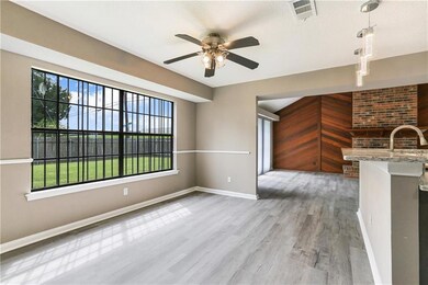 Dining with backyard view open to den and kitchen