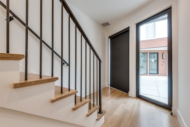 Stairs with wood finished floors and baseboards