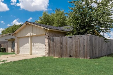 View of property exterior featuring a garage and a