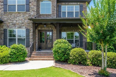 View of exterior entry with french doors and stone siding