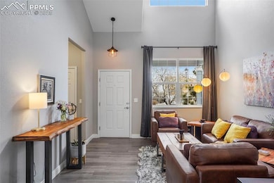 Entryway featuring baseboards, wood finished floor