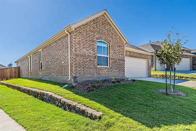 Single story home with brick siding, concrete driveway, and an attached garage