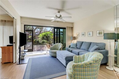 Living room featuring a ceiling fan and wood finis