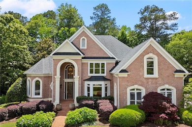 View of front facade with brick siding and roof with shingles