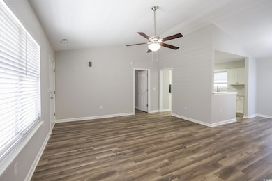 Unfurnished living room with dark wood-style floor