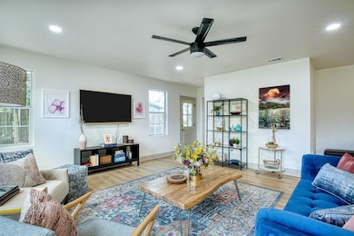 Living area featuring ceiling fan, wood finished 