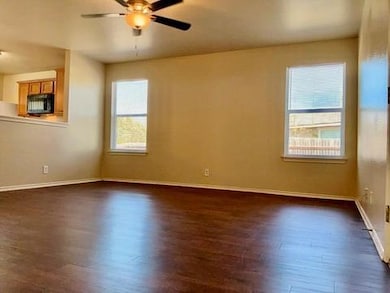 Spare room featuring dark wood-type flooring and 