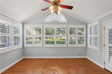 Unfurnished sunroom with vaulted ceiling and healthy amount of natural light