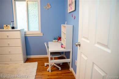 Bedroom with baseboards and light wood-type flooring