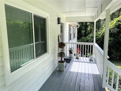 Wooden terrace featuring covered porch