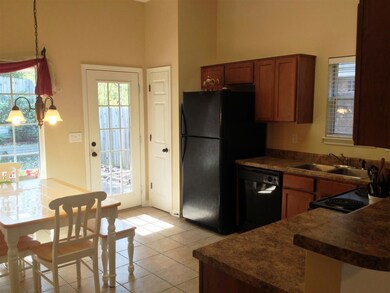 Spacious kitchen with tile floors and tons of natu