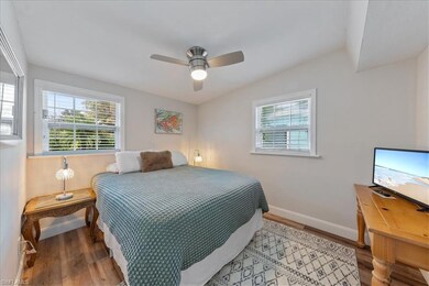 Bedroom featuring ceiling fan, baseboards, and woo