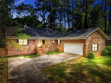 Ranch-style home with a porch, concrete driveway, 