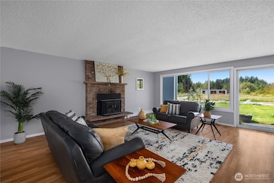 Living room with wood stove insert and views of the backyard & pastures