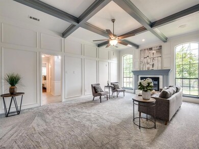 Soaring ceilings and fireplace anchor the middle of the home with split bedrooms.