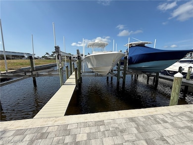Dock area with boat lift and a water view