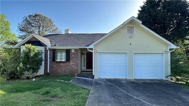 Ranch-style house featuring brick siding, an attac