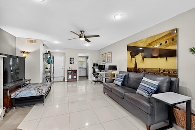 Living area with a desk, light tile patterned floors, ceiling fan, and recessed lighting