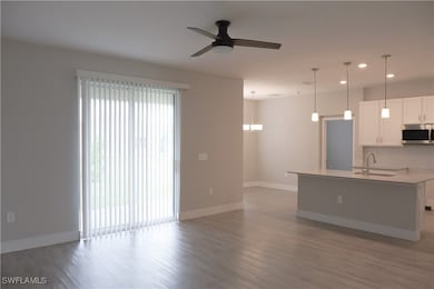 Kitchen featuring light wood finished floors, a si