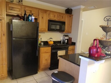 Kitchen with a breakfast bar area, granite counter