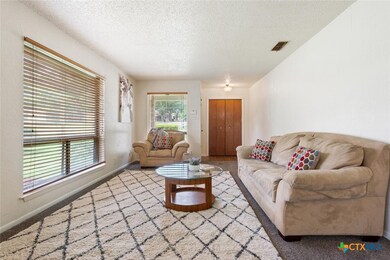 Recent carpet and fresh paint . Real wood blinds.  Coat closet at entry.