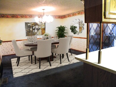 Large dining room has doors leading out to covered back porch.