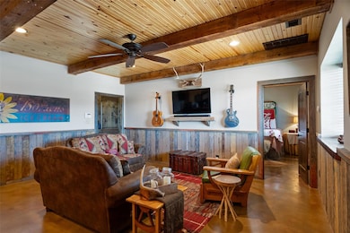 Living area with wood ceiling, finished concrete f