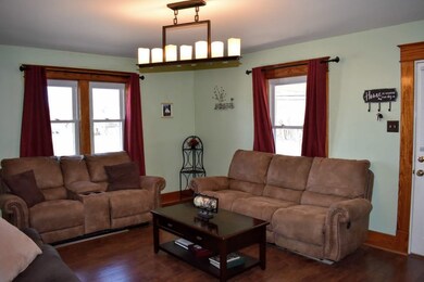 A cozy room that holds more furniture than you thi