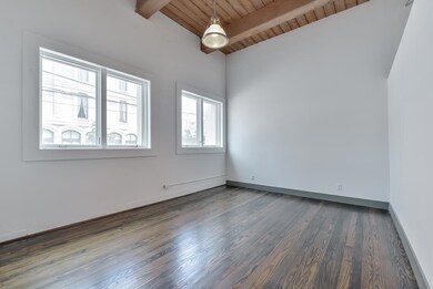 A wall of windows provides glimpses of 24th Street