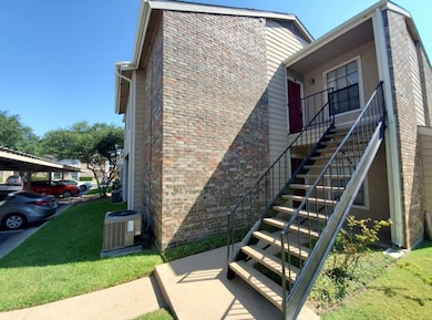 View of home's exterior with brick siding, stairwa