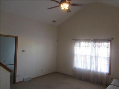 Living room features soaring cathedral ceilings