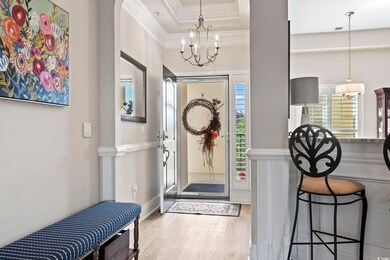 Entryway with a notable chandelier, ornamental mol