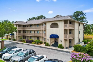 View of property featuring uncovered parking