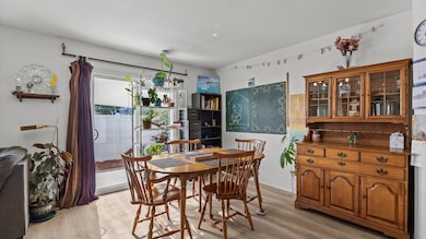 Combo living/dining area with sliding glass door to backyard patio.