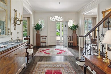 Entrance foyer with ornamental molding and dark ha