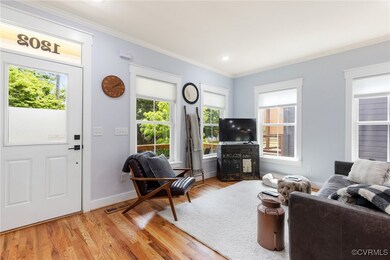 The well lit entryway starts the beautiful hardwoo