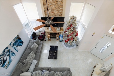 Living area featuring ceiling fan, a towering ceil