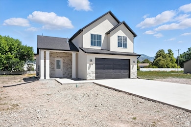Modern farmhouse with an attached garage, driveway, stone siding, stucco siding, and roof with shingles
