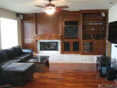 Wood floors and paneling enhance the family room