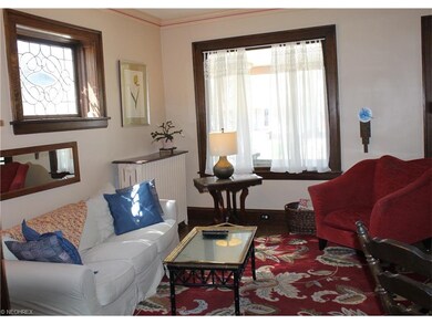 The living room sits to the right when entering through the front door.  It features refinished hardwood floors and large picture windows.