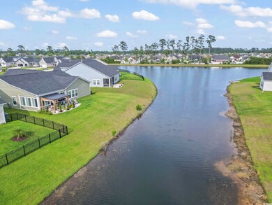 Water view with fence and nearby suburban area