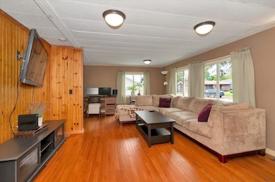 Living area featuring light wood-style flooring and baseboards