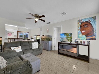 Tiled living room featuring ceiling fan