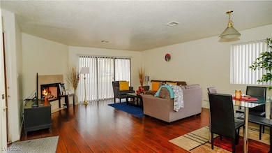 Living area with visible vents, hardwood / wood-st