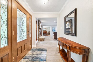 Step into the welcoming entry foyer, which opens t
