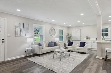 Living room featuring crown molding, dark wood-style flooring, recessed lighting, and baseboards
