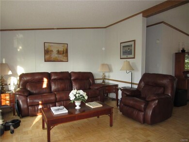 The living room is open and spacious w/wood parque