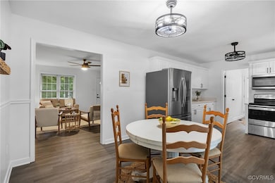 Dining space with dark wood finished floors, ceili