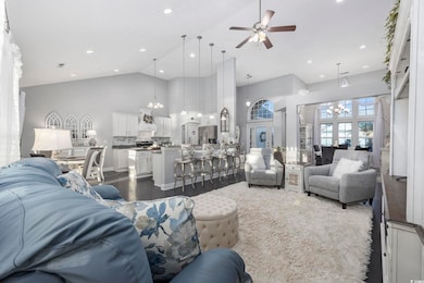 Living room with ceiling fan, dark hardwood / wood
