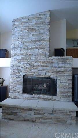 Spectacular stacked stone fireplace and hearth.
